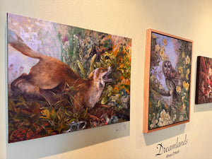 Artistic representations of animals in nature on a wall with 'Dreamlands' branding.