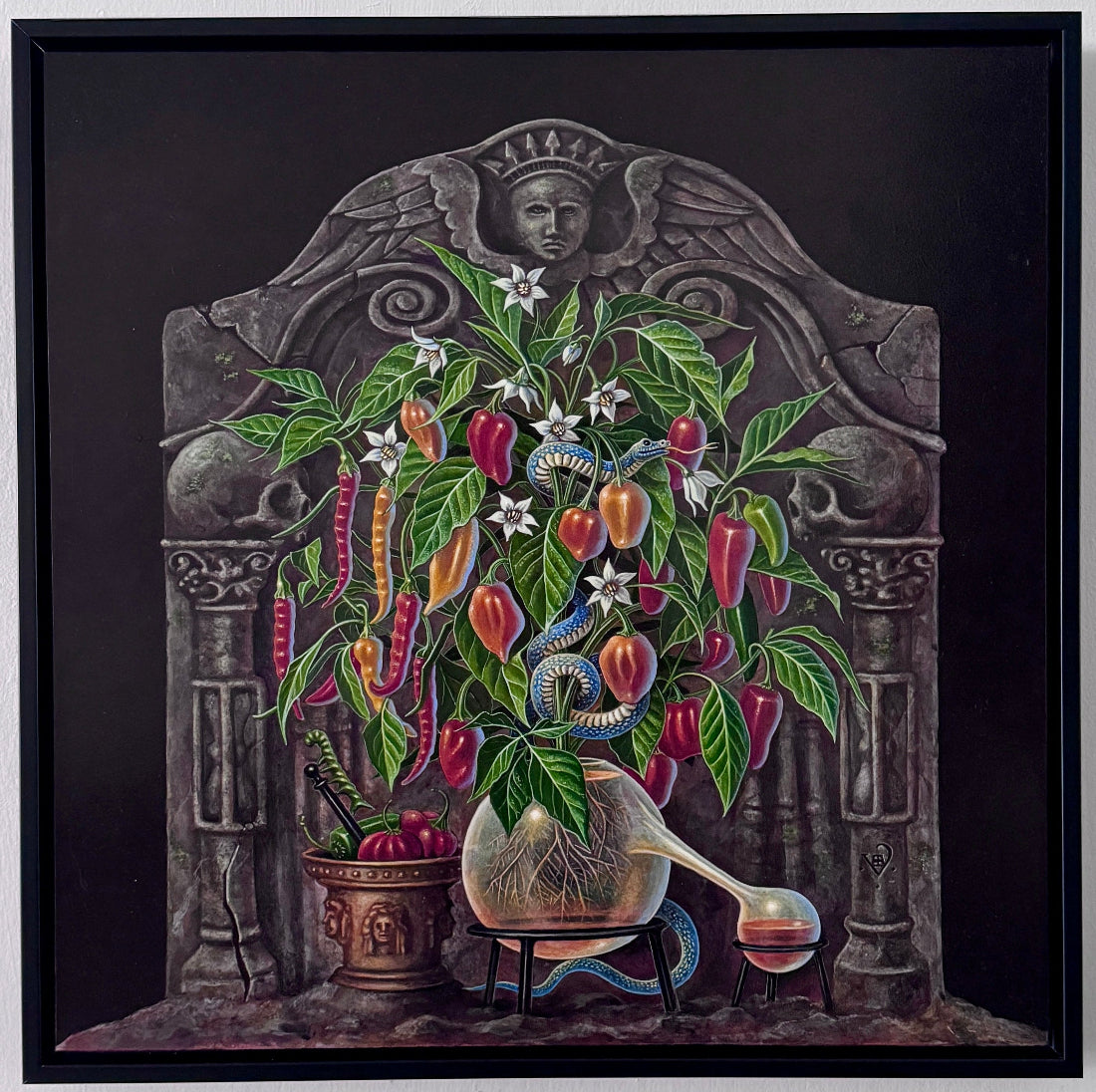 A framed square art print depicting a surreal still life of a vase filled with colorful peppers, flowers, and a spoon, set against a dark stone-like backdrop, hung on a white wall.