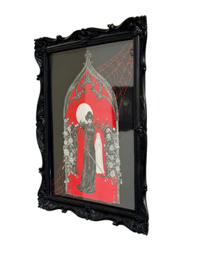 Ink drawing with black frame and artistic design on a white wall