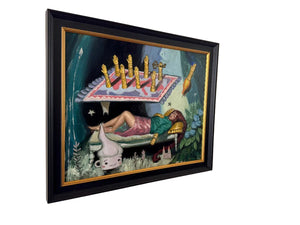 Framed artwork on a wall with a person lying down and candles.