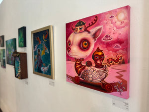 Art gallery wall with various artworks, including a prominent pink painting of a creature.