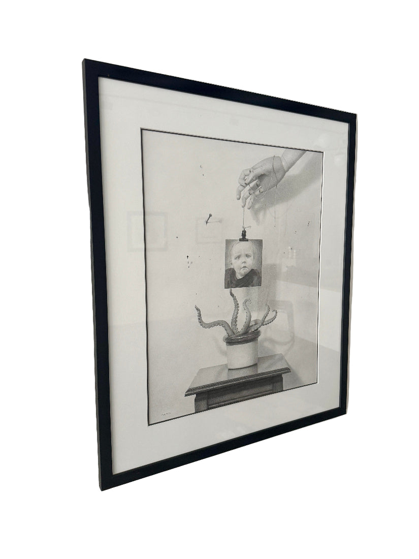Framed black and white drawing on a wall