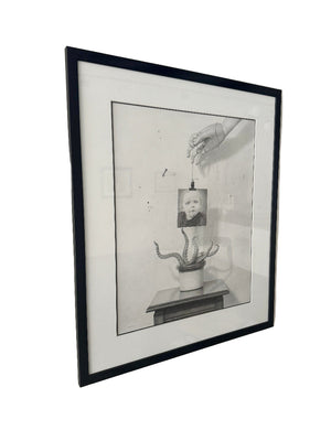 Framed black and white drawing on a wall