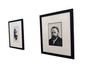 Framed black and white drawings on a wall