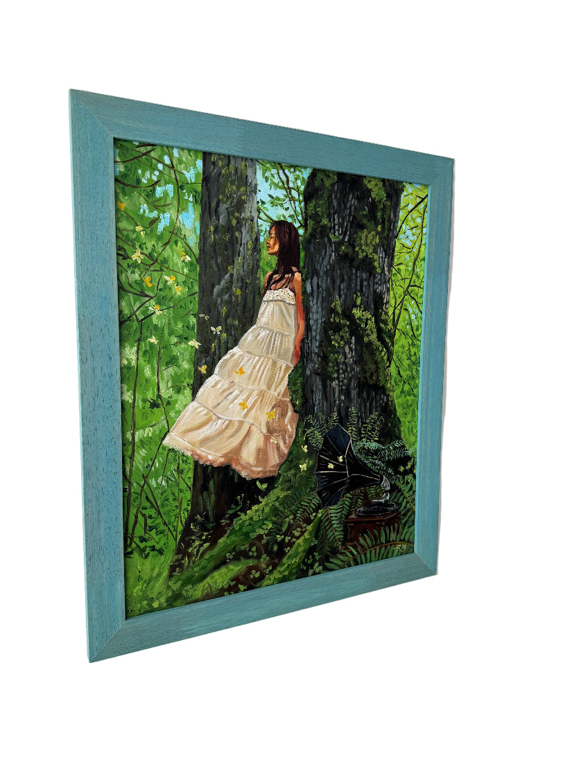 Framed artwork of a woman on a log in a forest setting.