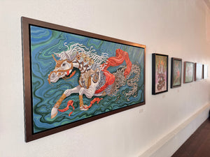 Framed artwork of a horse on a wall with other framed pieces.