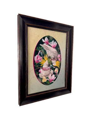 Framed artwork of birds and flowers on a beige wall