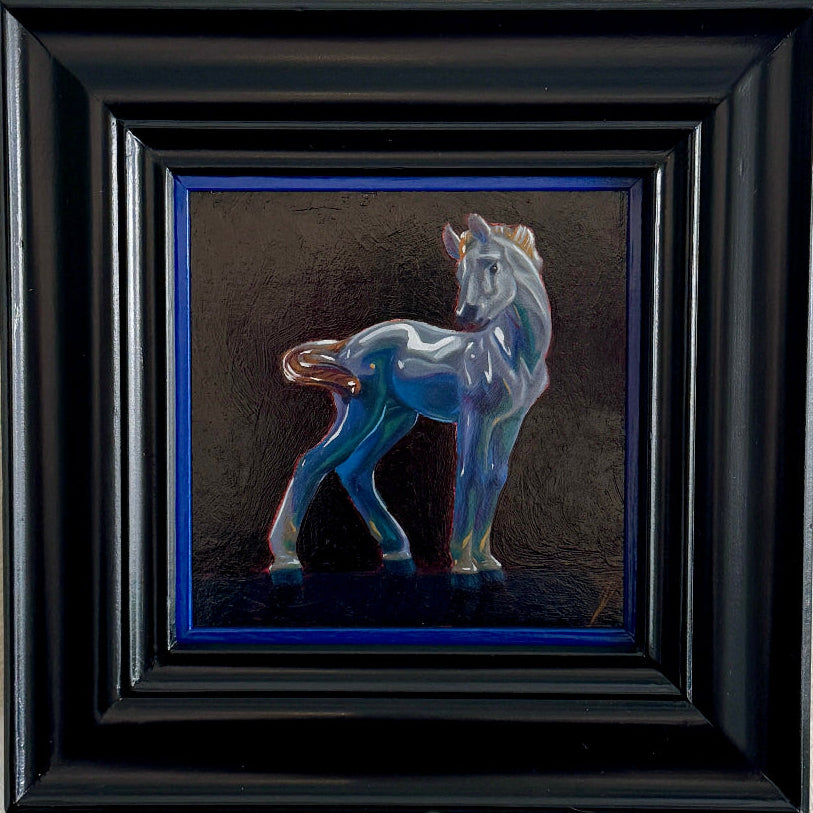 Colorful horse figurine on a dark background