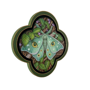 Decorative plate with a green moth design on a white background