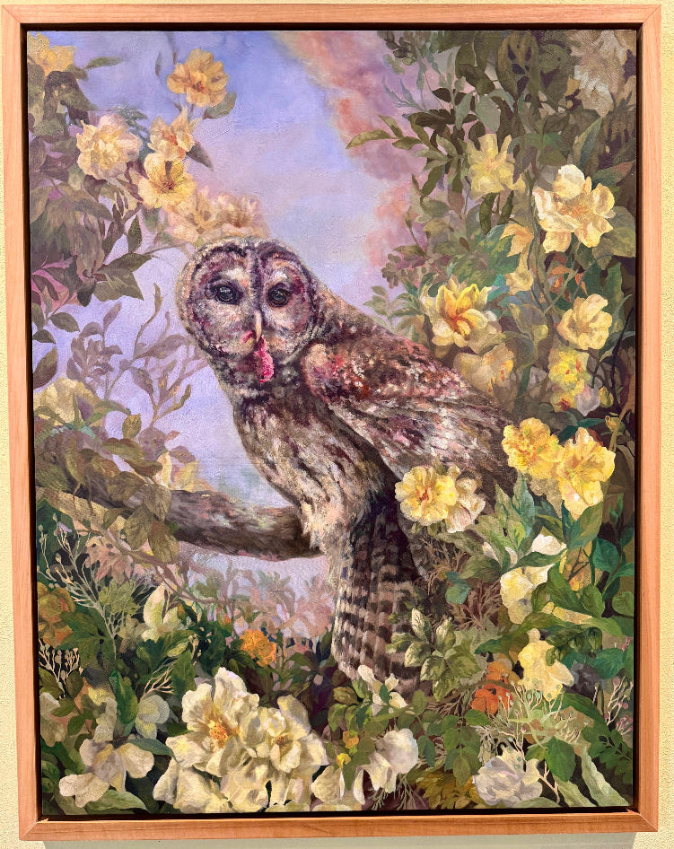 Framed artwork of an owl among flowers on a wall