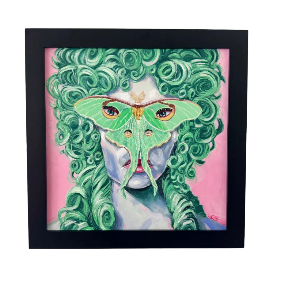 Framed artwork of a woman with green hair and a green moth on her face against a pink background.