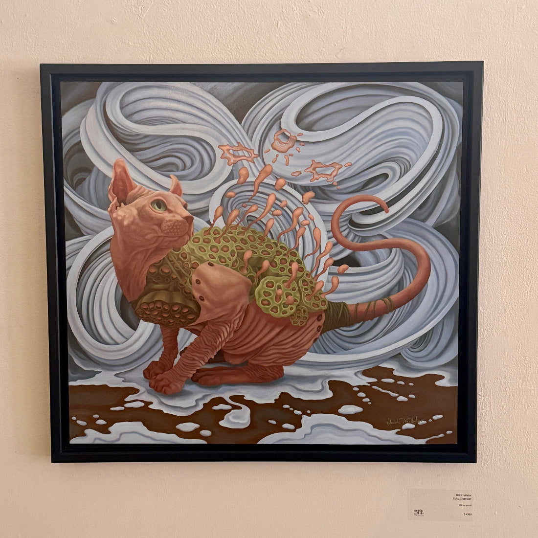 Framed artwork of a cat with a futuristic design on a textured wall.