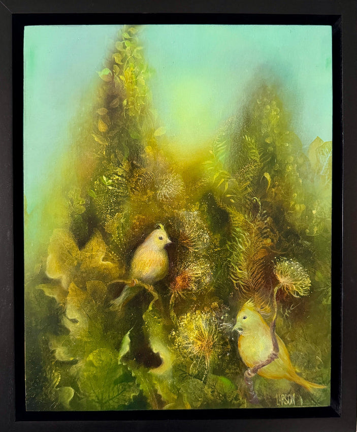 Framed artwork of two birds in a forest setting on a beige wall.