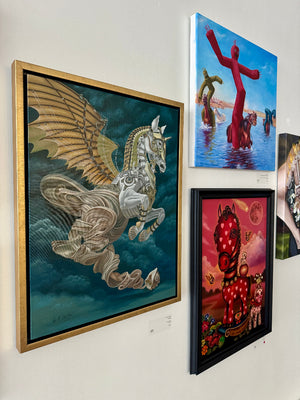 Wall with framed artworks including a winged horse, abstract figure, and other colorful pieces.