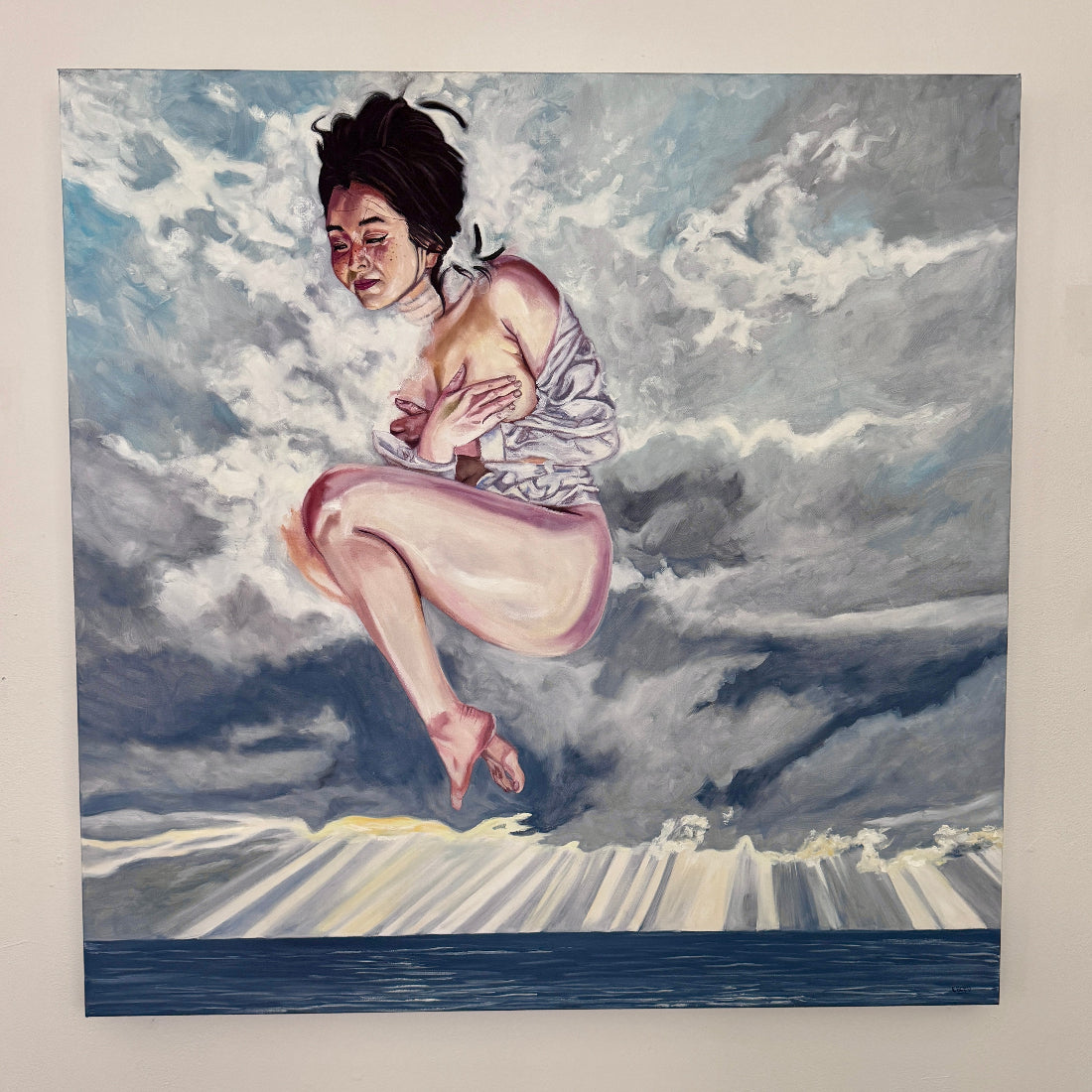 Artistic depiction of a person sitting on a cloud with a dramatic sky background