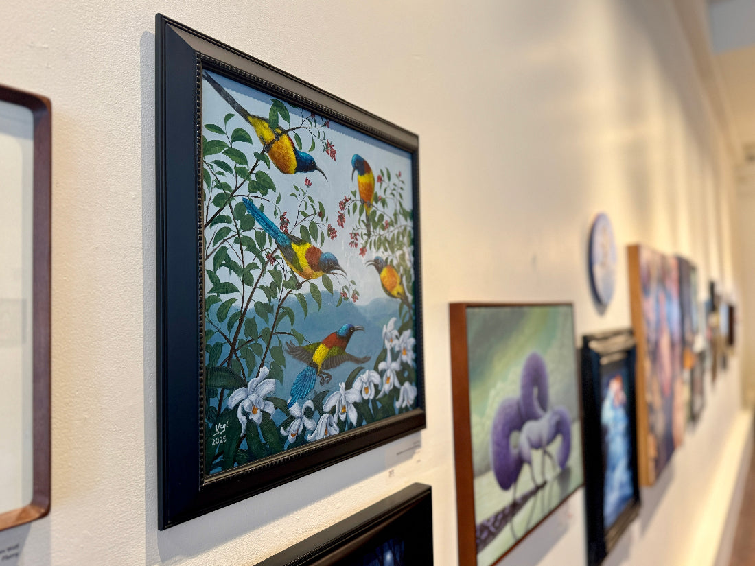 Art gallery with various framed paintings on a wall