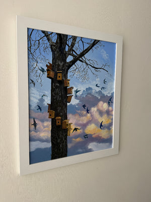 Framed artwork of birds perched on a tree with a colorful sky.