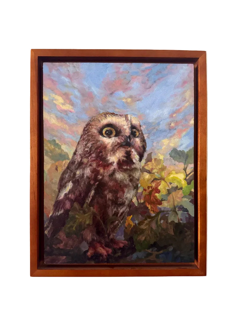 Framed painting of an owl with a colorful background on a white wall