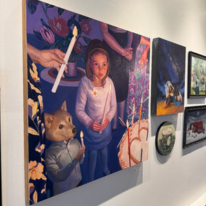 Art gallery wall with various paintings, including a prominent one of a girl holding candles.