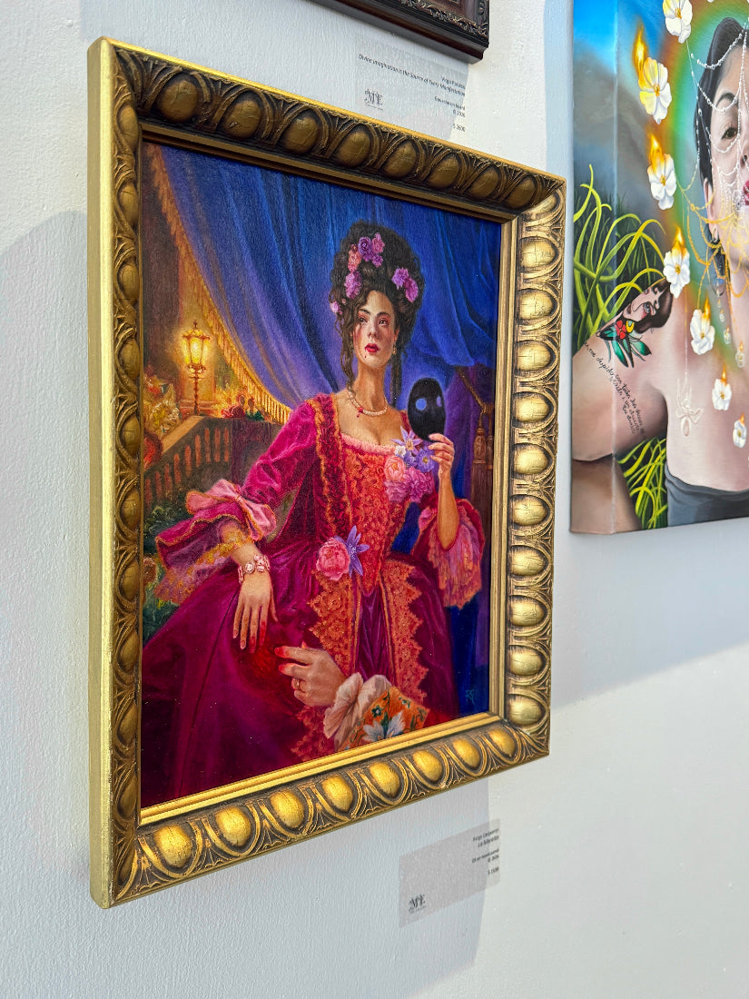 A framed portrait painting of a woman in a rich magenta and red gown with a dark blue curtain background, displayed on a gallery wall. The painting is housed in an ornate gold frame, with other colorful art pieces partially visible on either side.