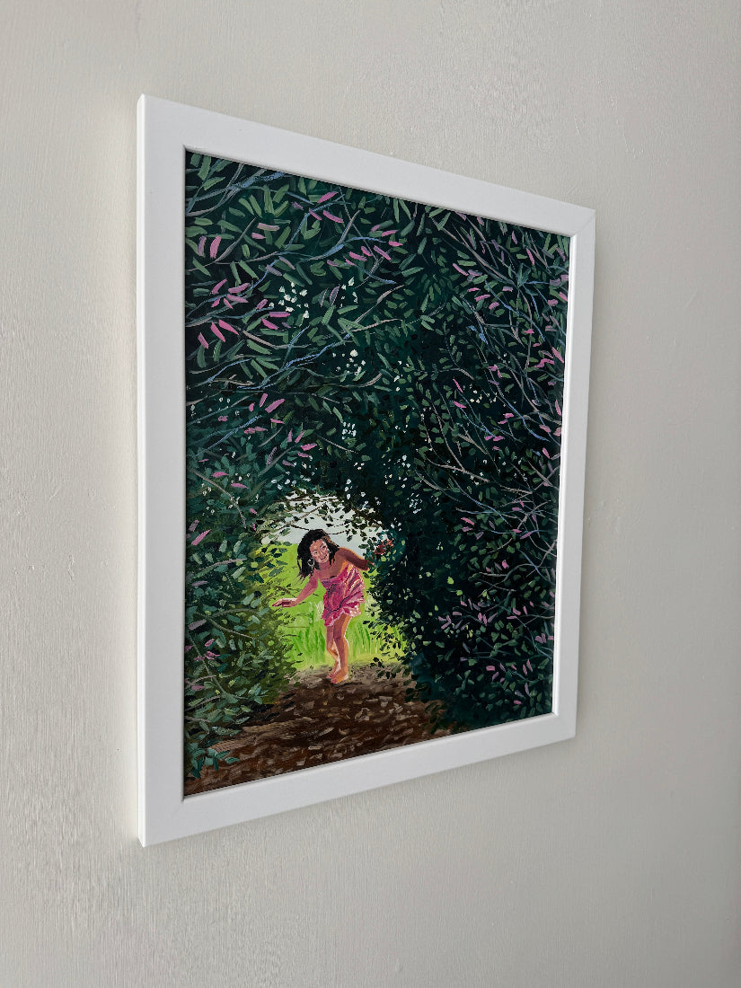 Framed artwork of a person walking with trees and flowers in the background.
