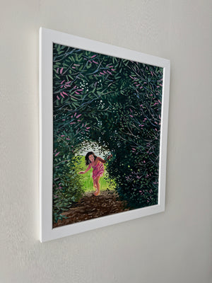 Framed artwork of a person walking with trees and flowers in the background.