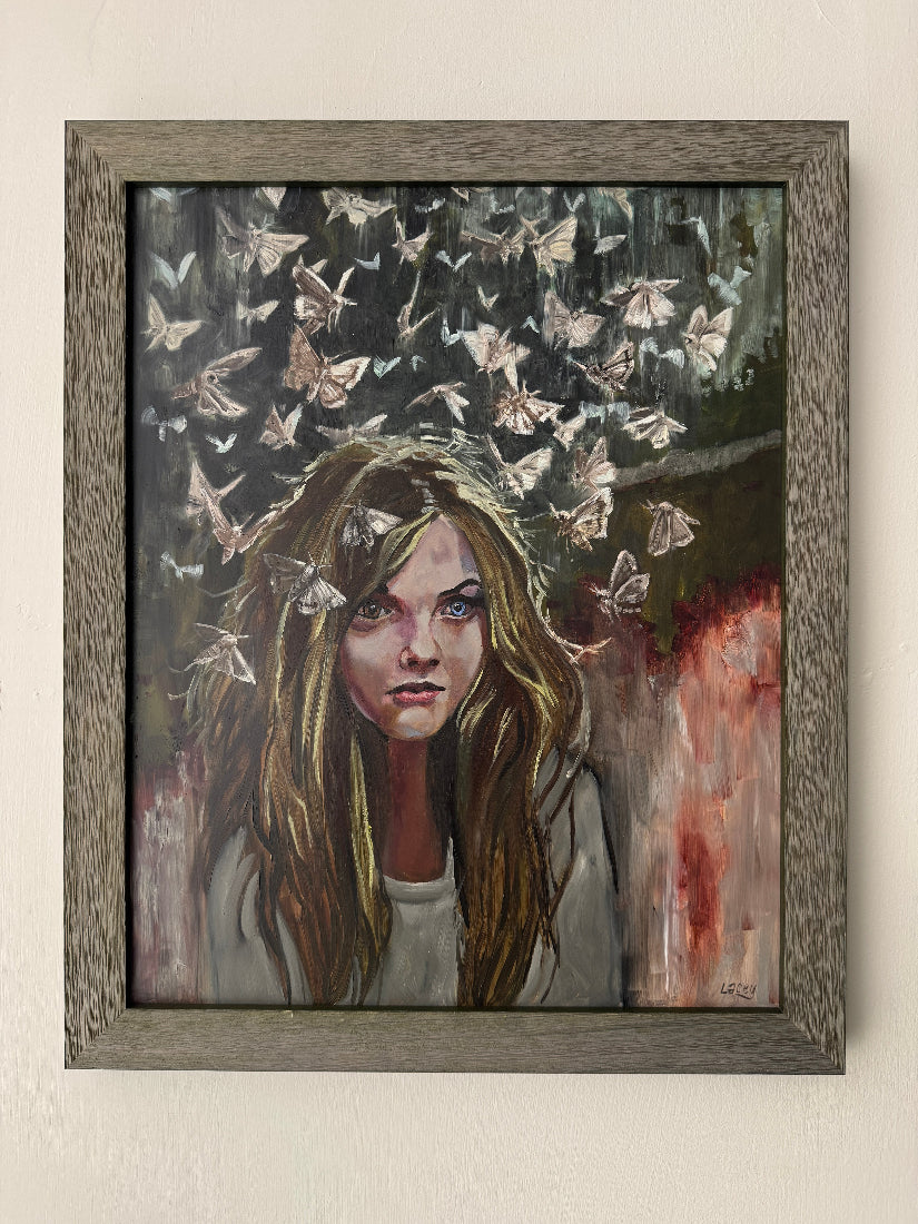 Framed painting of a woman with long hair and butterflies on a dark background