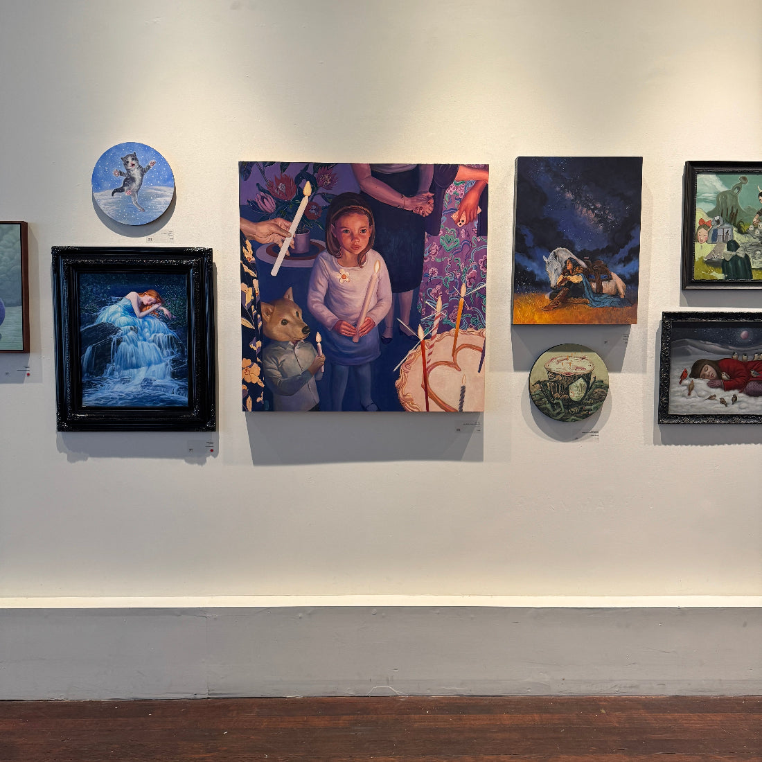 Art gallery wall with various paintings and artworks.