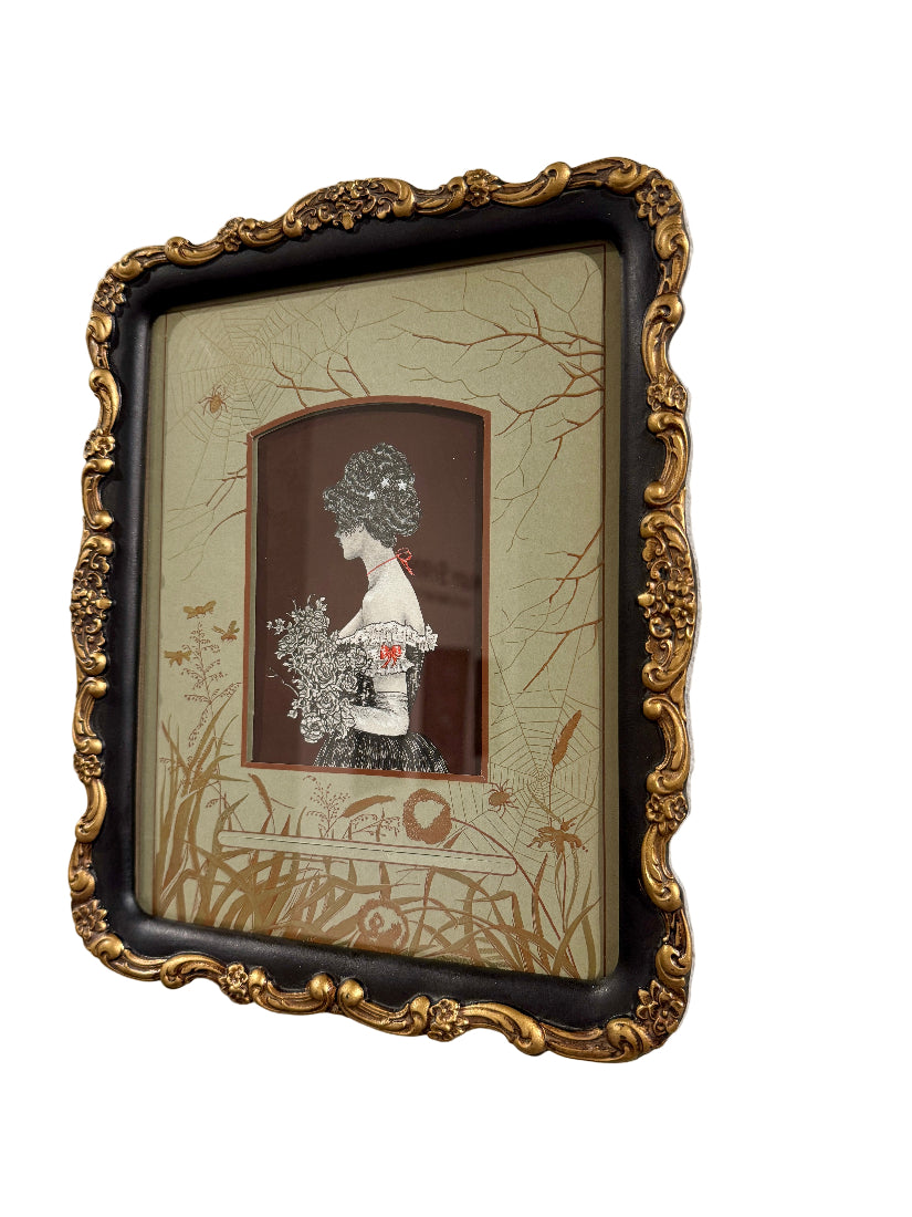 Framed artwork of a woman with flowers on a textured wall
