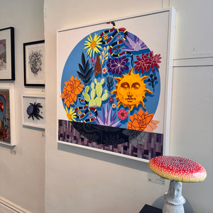 Colorful abstract artwork with a sun and flowers on a wall, with a small mushroom-shaped stool in front.