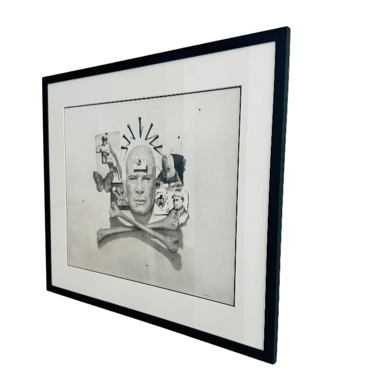 Framed black and white artwork on a plain wall