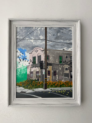 Framed artwork with a cityscape view through a window