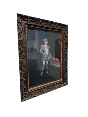 Framed artwork of a skeleton holding a red heart on a white wall.