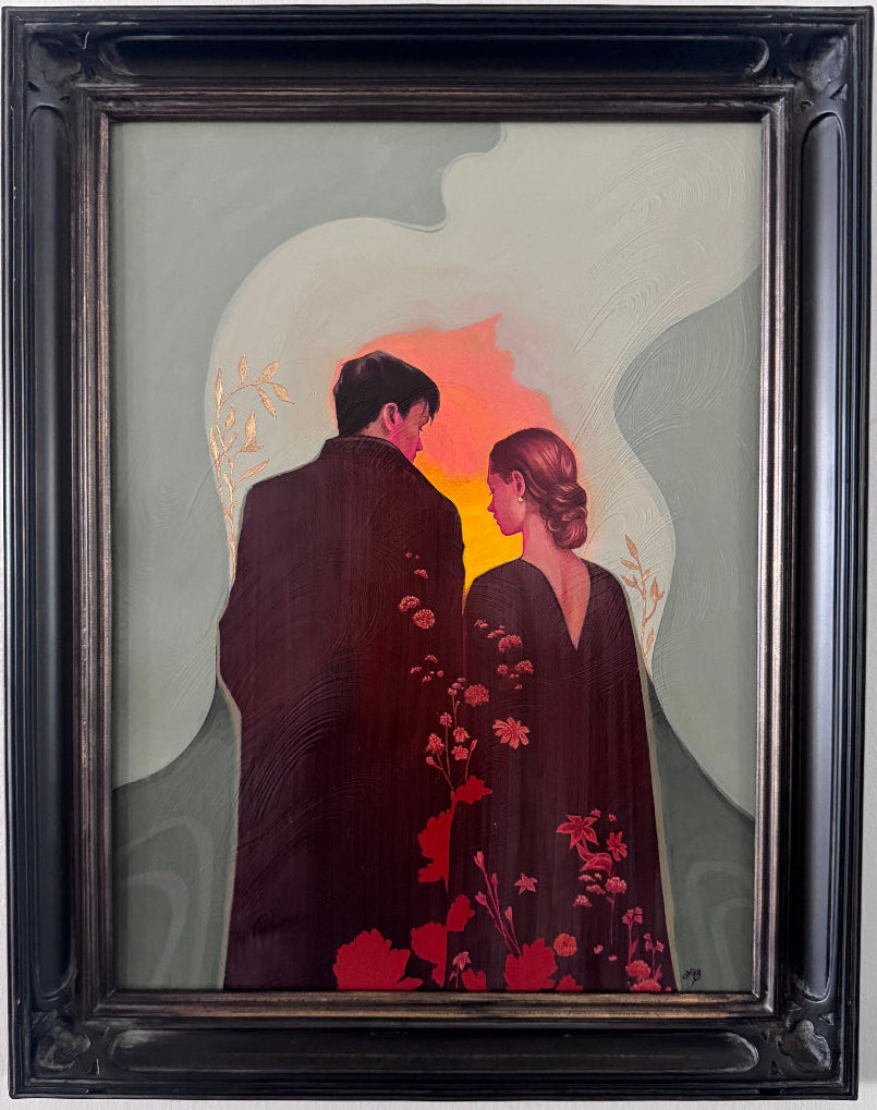 A framed painting depicting a couple from behind, standing in front of a glowing orange and pink sky with pale green abstract shapes in the background. The artwork is housed in a thick, ornate black wooden frame and is mounted on a white wall.