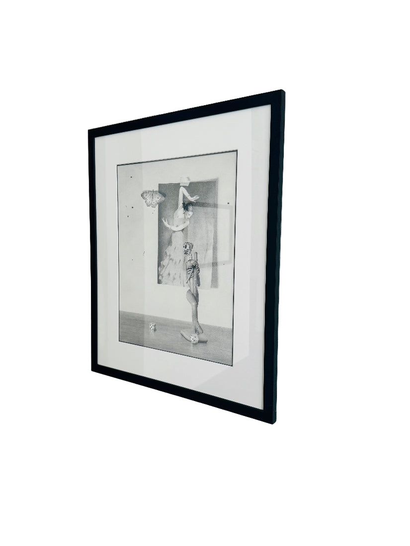 Framed black and white drawing on a plain wall