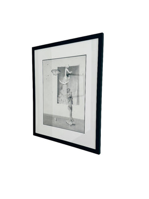 Framed black and white drawing on a plain wall