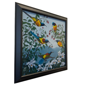 Framed artwork of colorful birds on a branch with flowers on a beige wall.