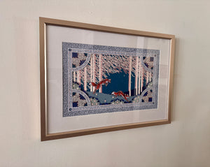 Framed artwork of two foxes in a snowy forest scene on a beige wall.