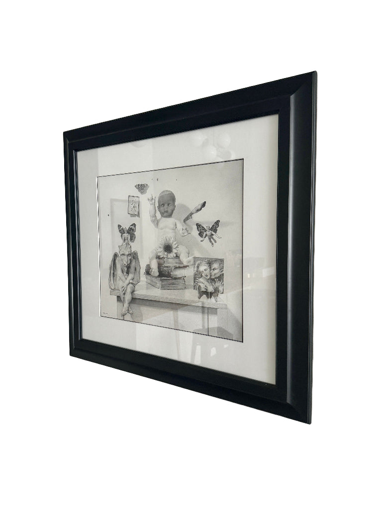 Framed black and white artwork on a light gray wall
