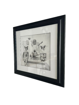 Framed black and white artwork on a light gray wall