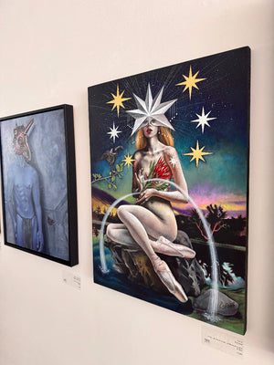 Art gallery with two paintings on a wall, one featuring a woman with stars and another with a figure in a room.