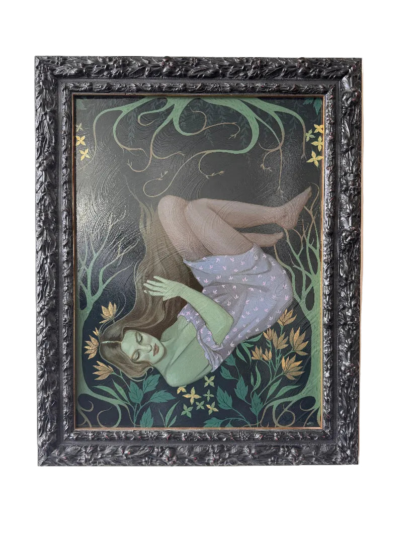 Framed artwork of a woman lying on her back with floral elements