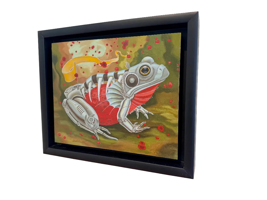 Framed artwork of a stylized frog on a textured wall.
