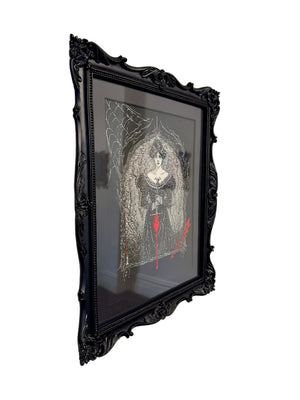 Framed artwork of a woman with a red sword on a beige wall