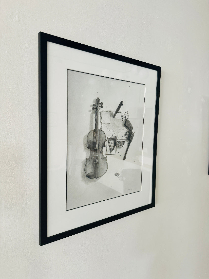 Framed black and white artwork of a violin and a person on a wall.