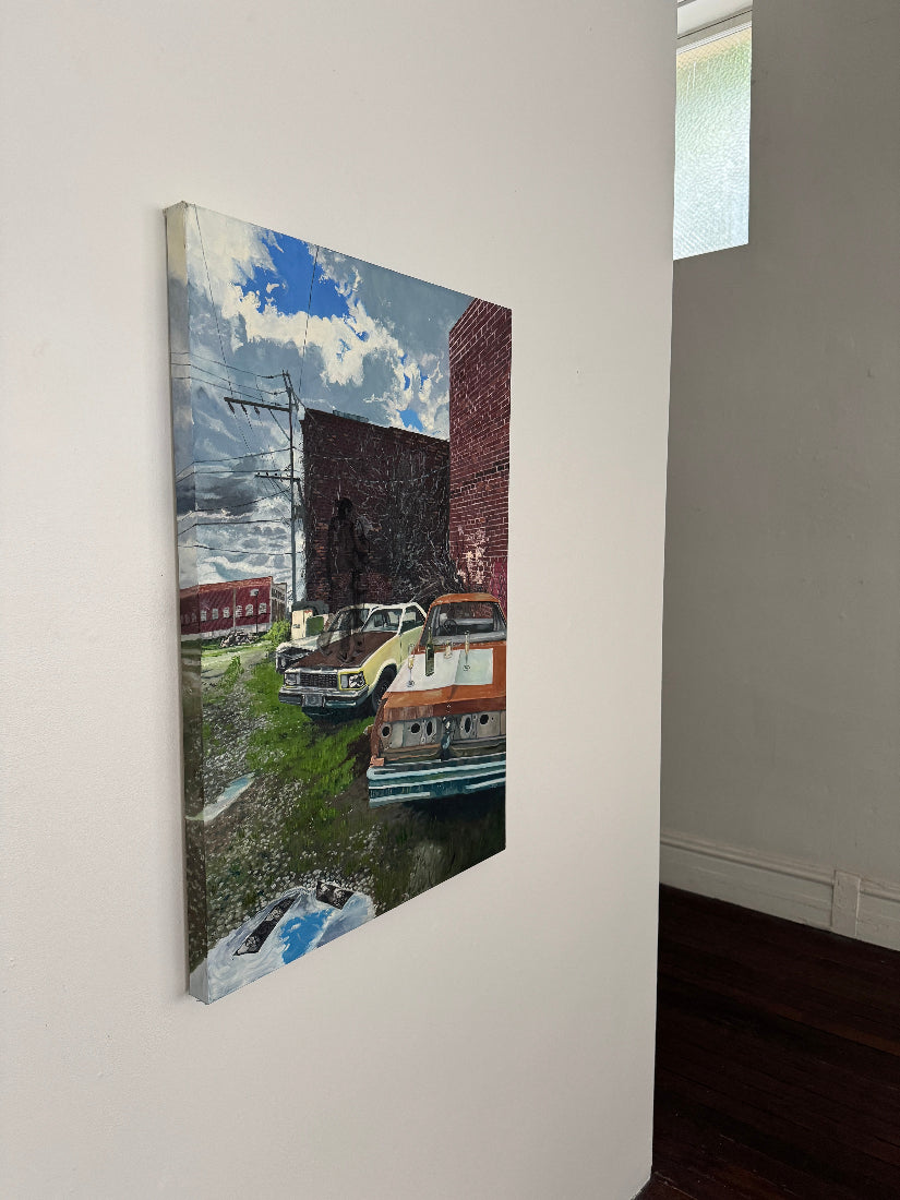 Canvas painting of a landscape with a building on a white surface