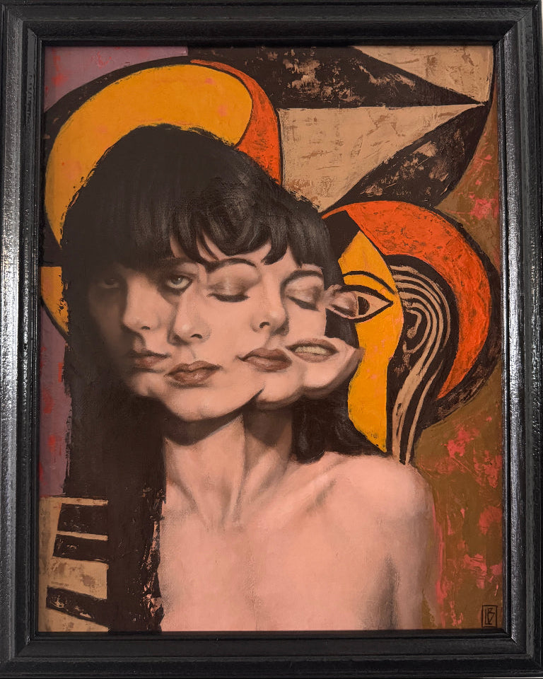 Framed artwork of a stylized portrait with abstract elements on a beige wall.