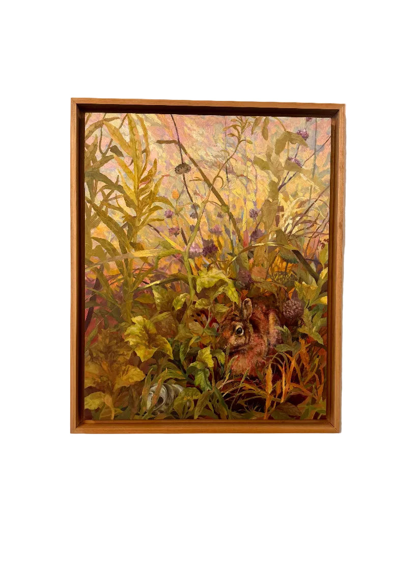 Framed painting of a natural scene with plants and animals on a beige wall.