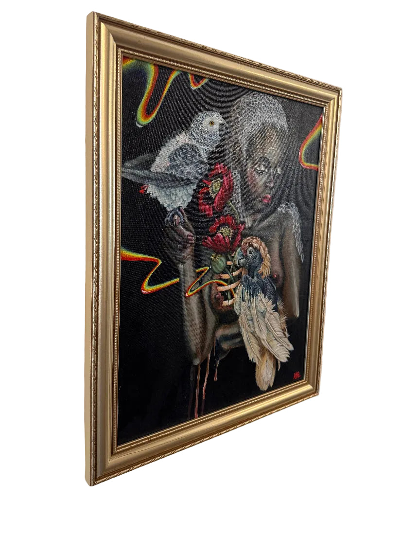 A framed surreal painting hanging on a light wall. The artwork depicts a seated figure holding red flowers and two birds against a black background, with a gold frame around the piece.