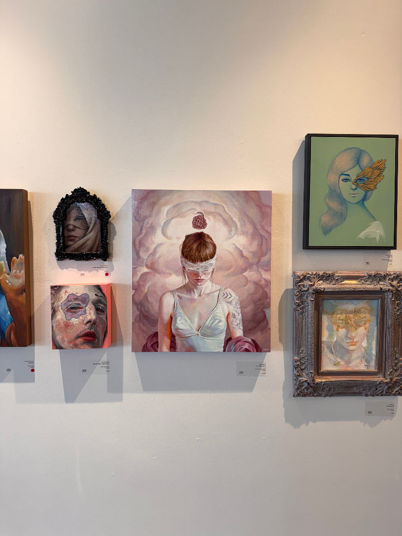Art gallery with various paintings on a wall